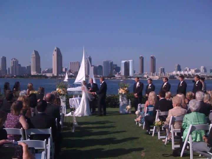 Outdoor waterfront wedding ceremony with the city skyline behind the altar