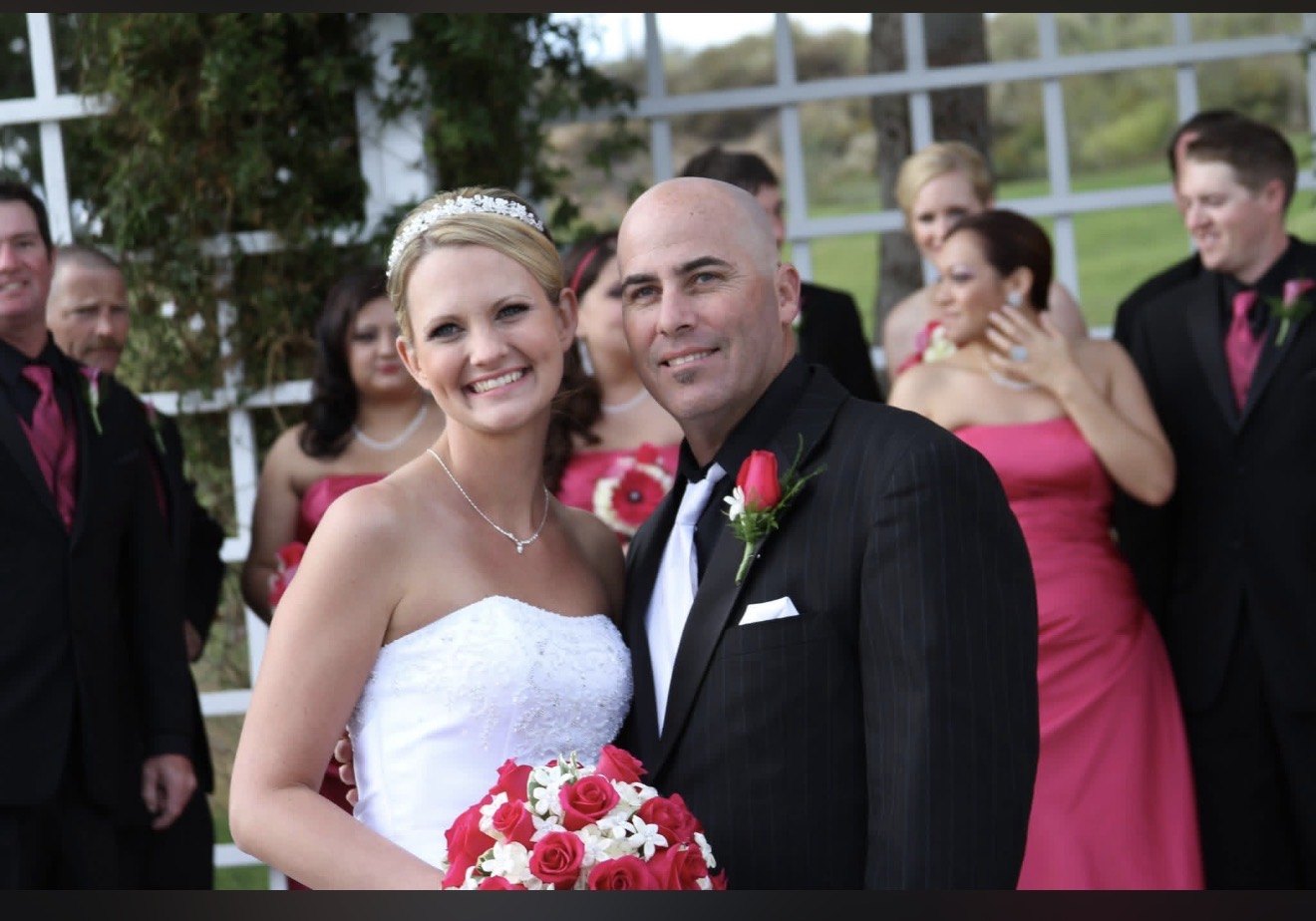 Bride and groom with their wedding party in pink and black formalwear