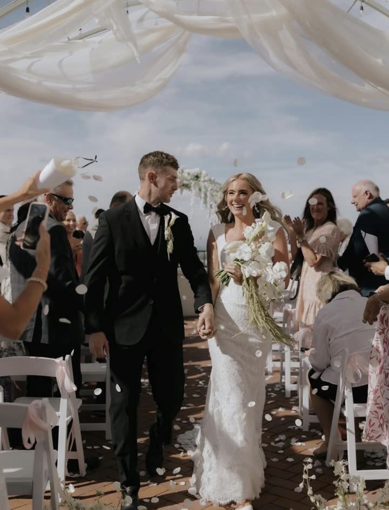 Bride and groom walking down the aisle together after their ceremony